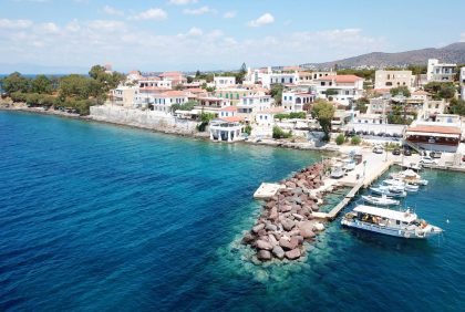 Aerial drone bird's eye view photo of port and traditional fishing village of Perdika in island of Aigina, Saronic Gulf, Greece